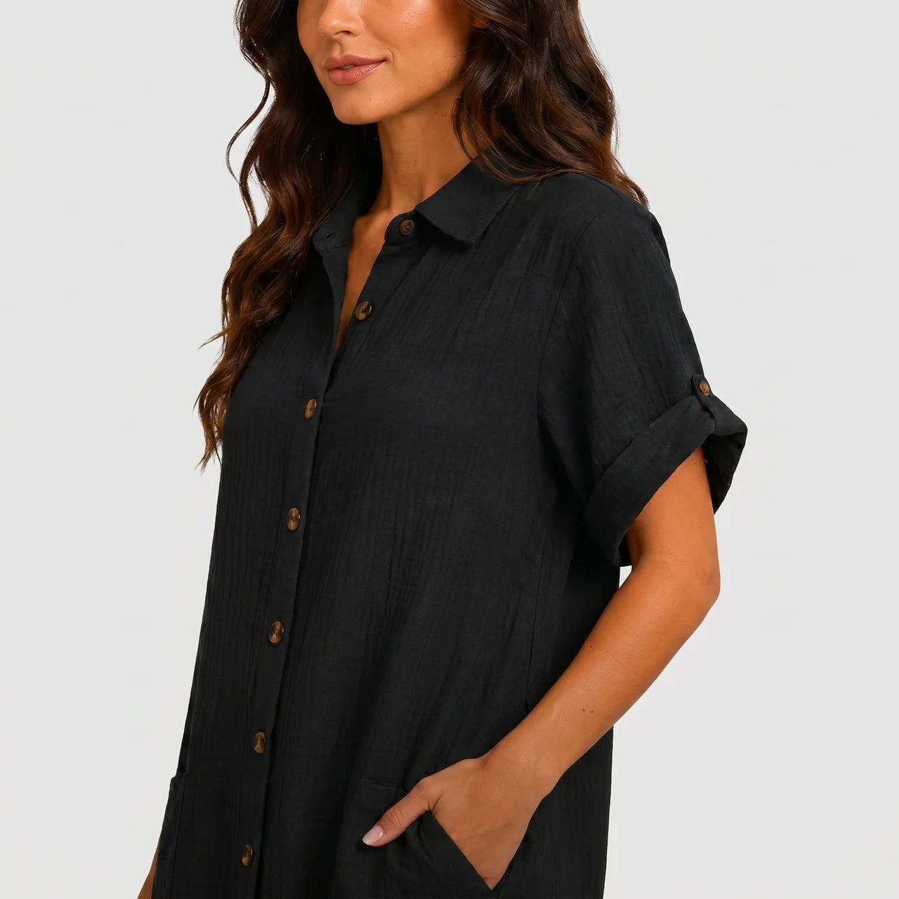 Close-up view of black button front midi dress with short sleeves and side pockets by BELLA HUDSON