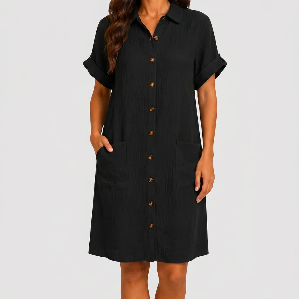 Front view of black button front midi dress with short sleeves and side pockets by BELLA HUDSON
