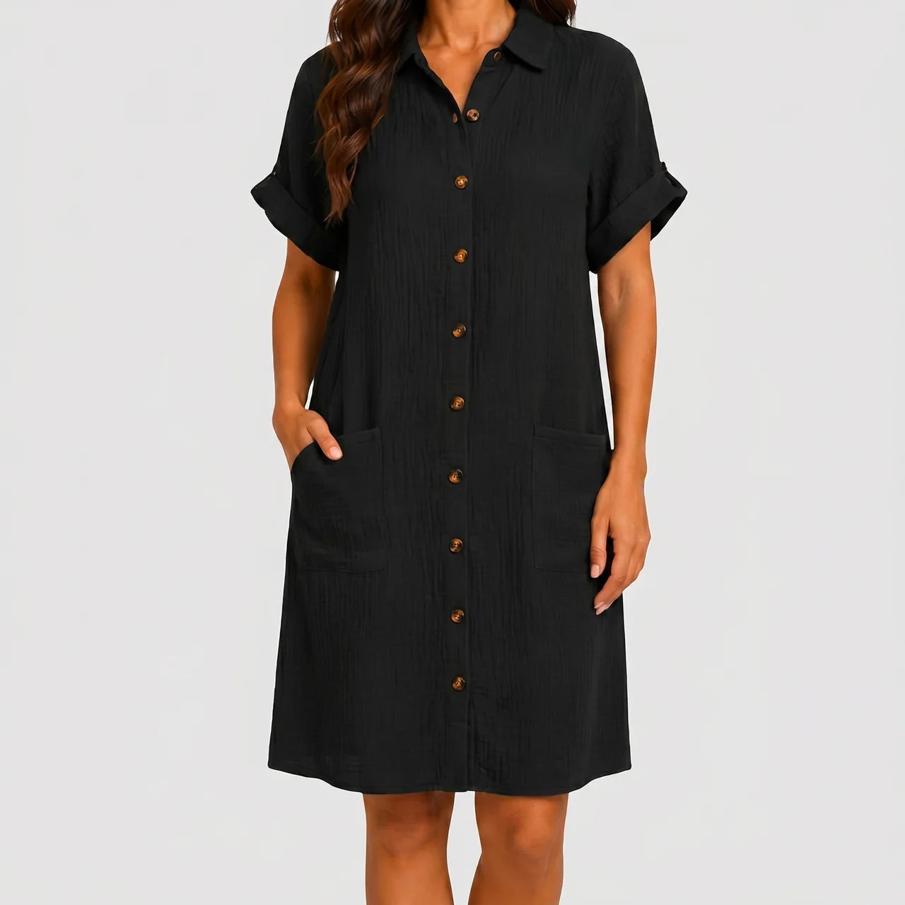 Front view of black button front midi dress with short sleeves and side pockets by BELLA HUDSON