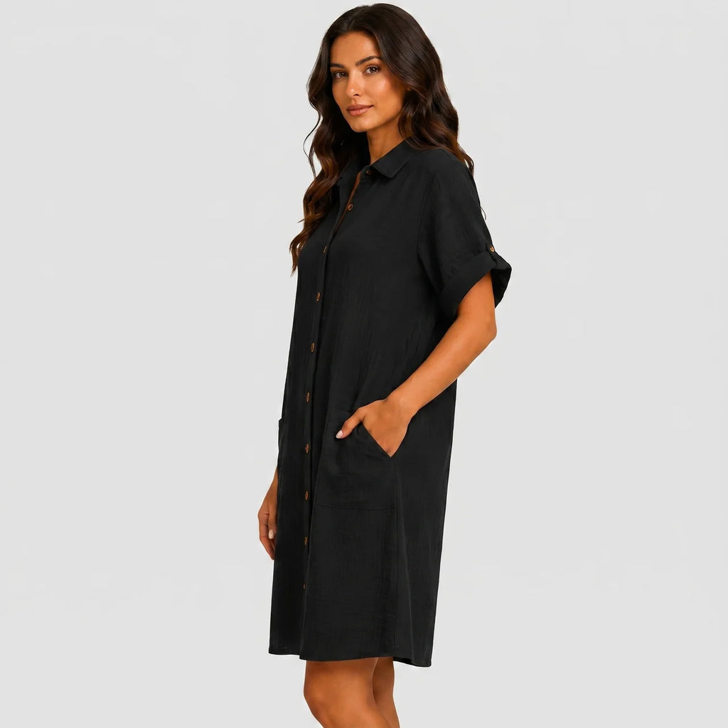 Side view of black button front midi dress with short sleeves and side pockets by BELLA HUDSON
