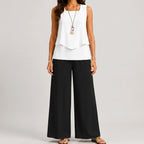 Front view of black layered sleeveless top and wide leg pants set by BELLA HUDSON