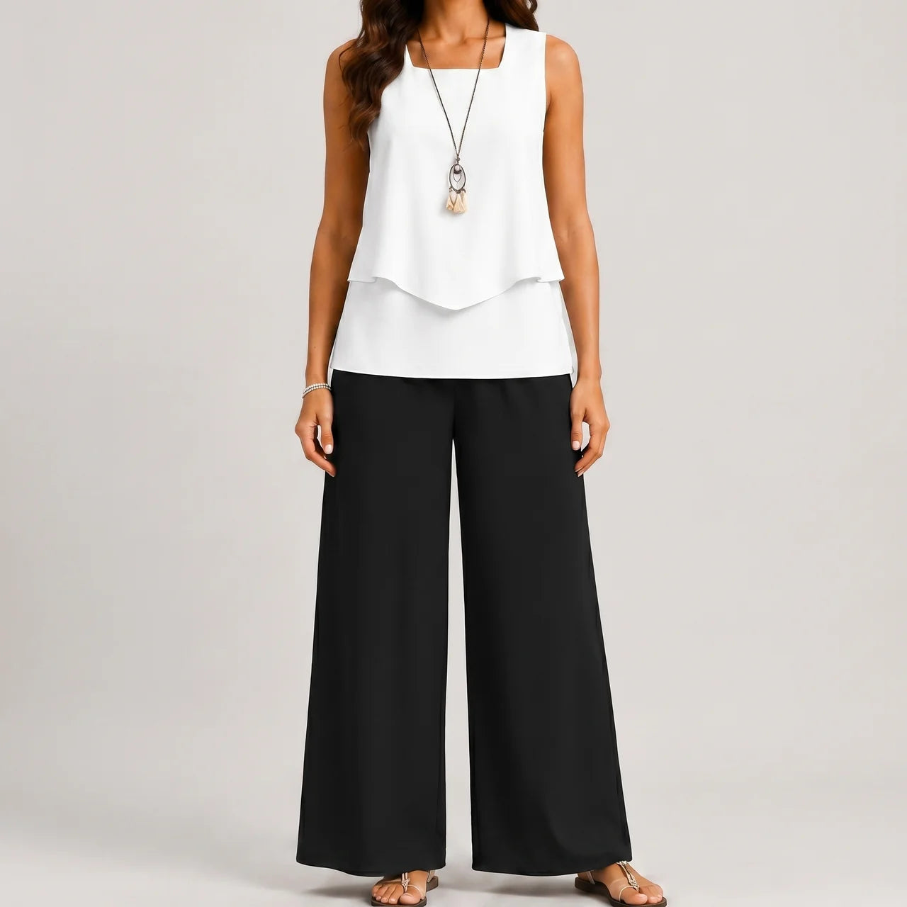Front view of black layered sleeveless top and wide leg pants set by BELLA HUDSON