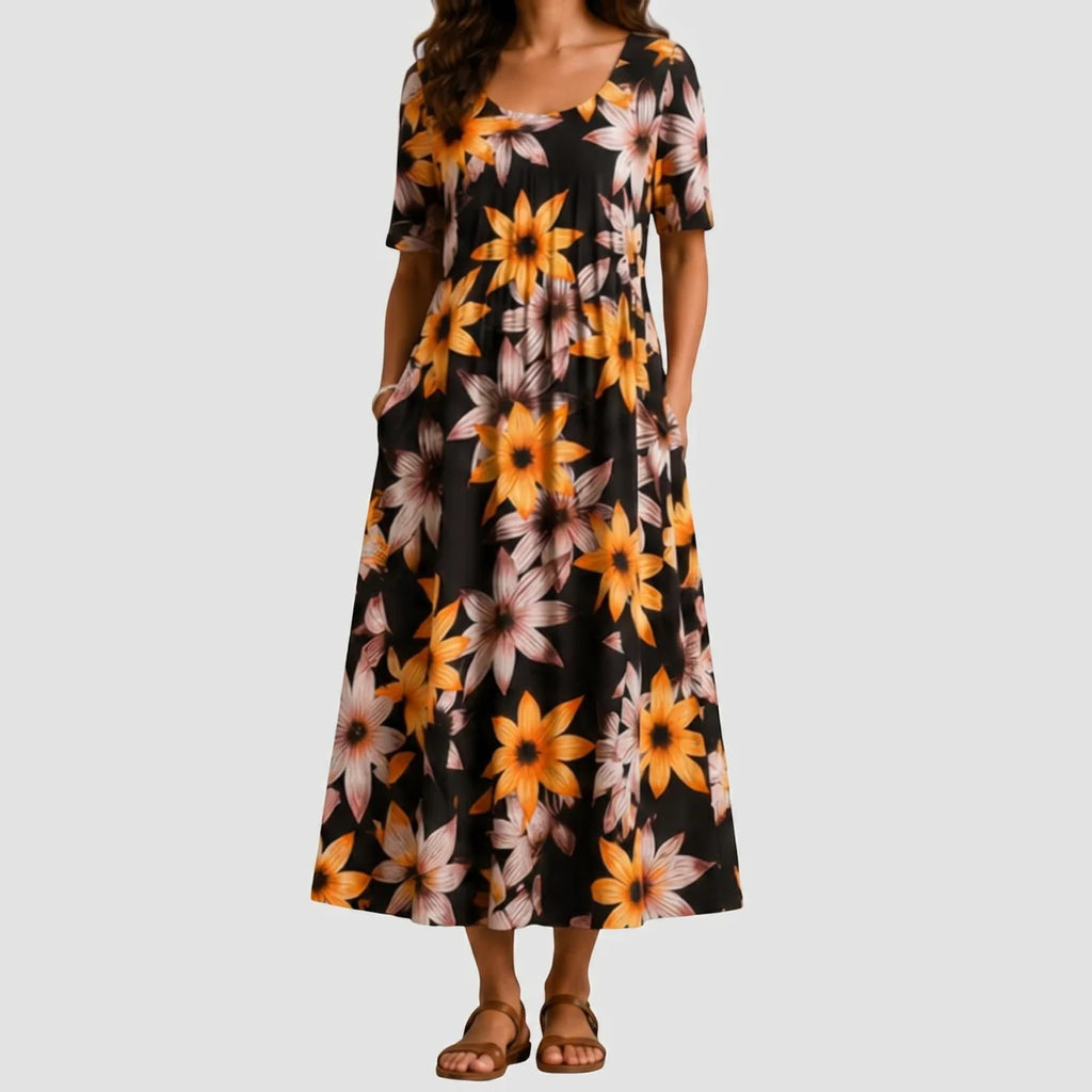 Black floral maxi dress with orange flower print, short sleeves, and pockets front view BELLA HUDSON
