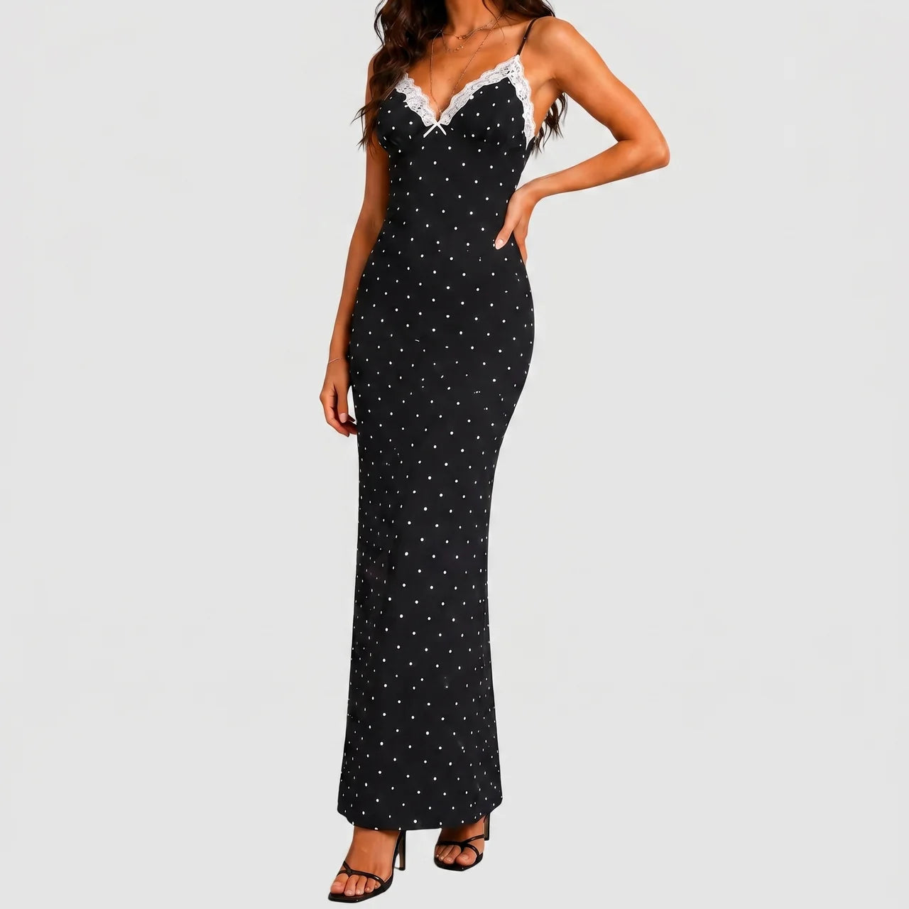 Front view of black polka dot maxi dress with white lace trim and spaghetti straps by BELLA HUDSON