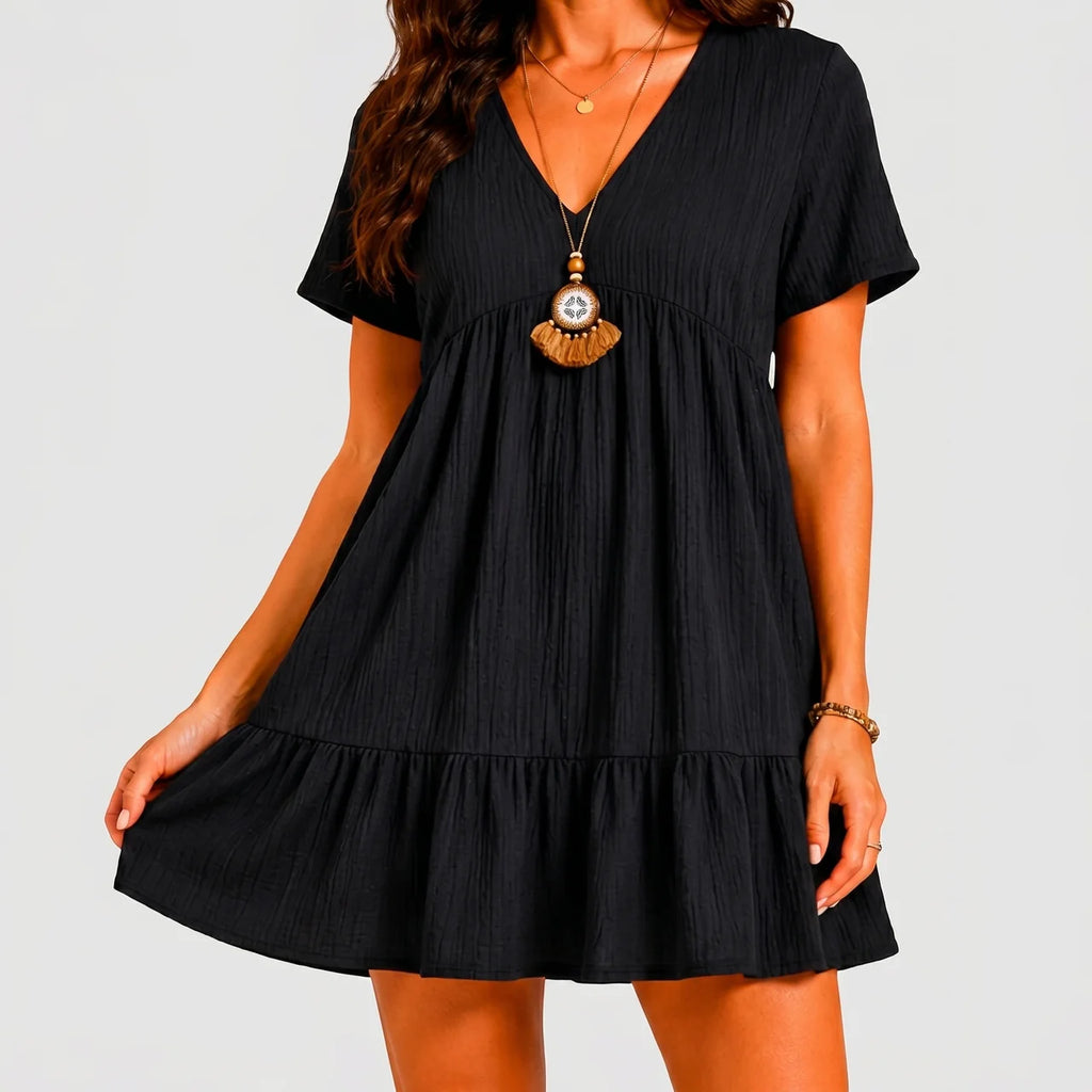 Front view of black tiered mini dress with relaxed fit and short sleeves by BELLA HUDSON