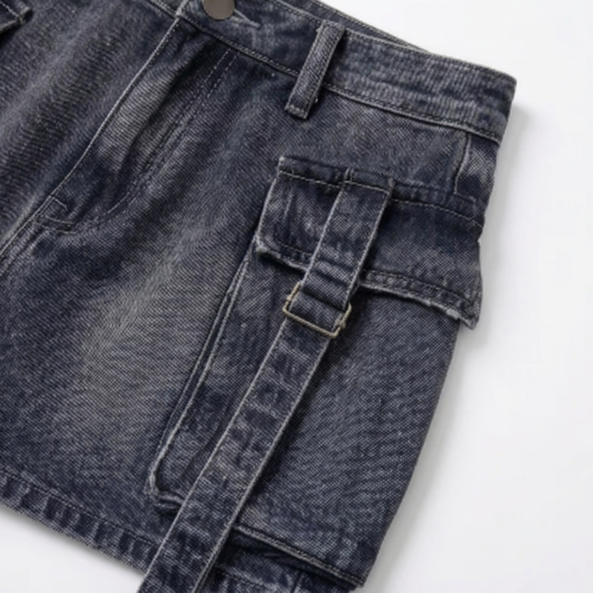 Close-up of blue denim cargo mini skirt with pocket and belt detail BELLA HUDSON