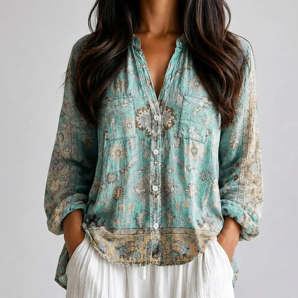 Close-up front view of blue green floral boho lightweight blouse with button front, chest pockets, and long sleeves BELLA HUDSON.