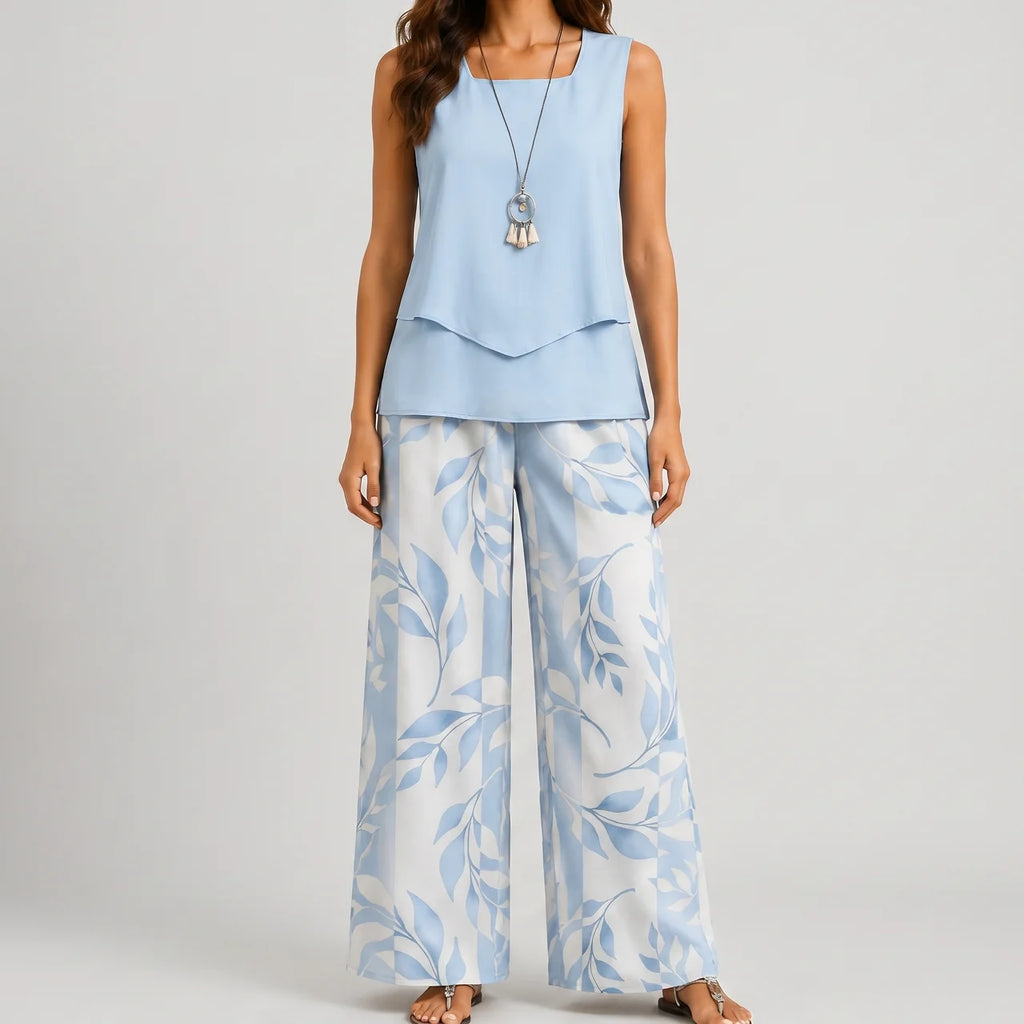 Front view of blue layered sleeveless top and wide leg pants set with floral print by BELLA HUDSON