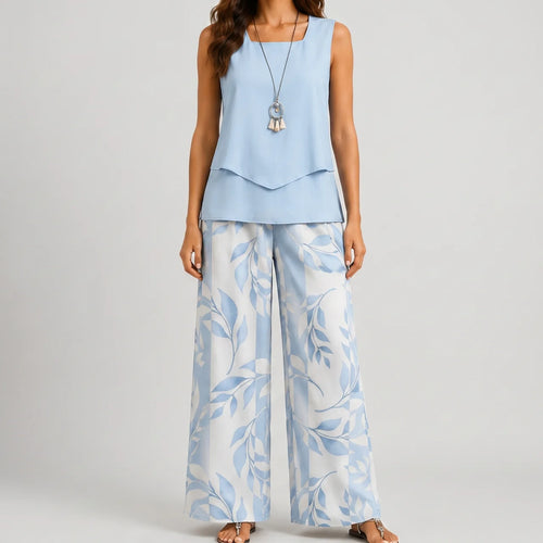 Front view of blue layered sleeveless top and wide leg pants set with floral print by BELLA HUDSON