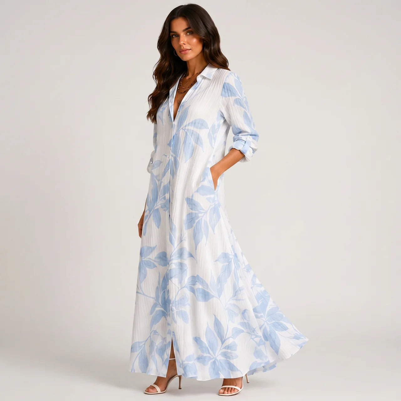 Side view of blue and white tropical print maxi dress with flowing silhouette by BELLA HUDSON
