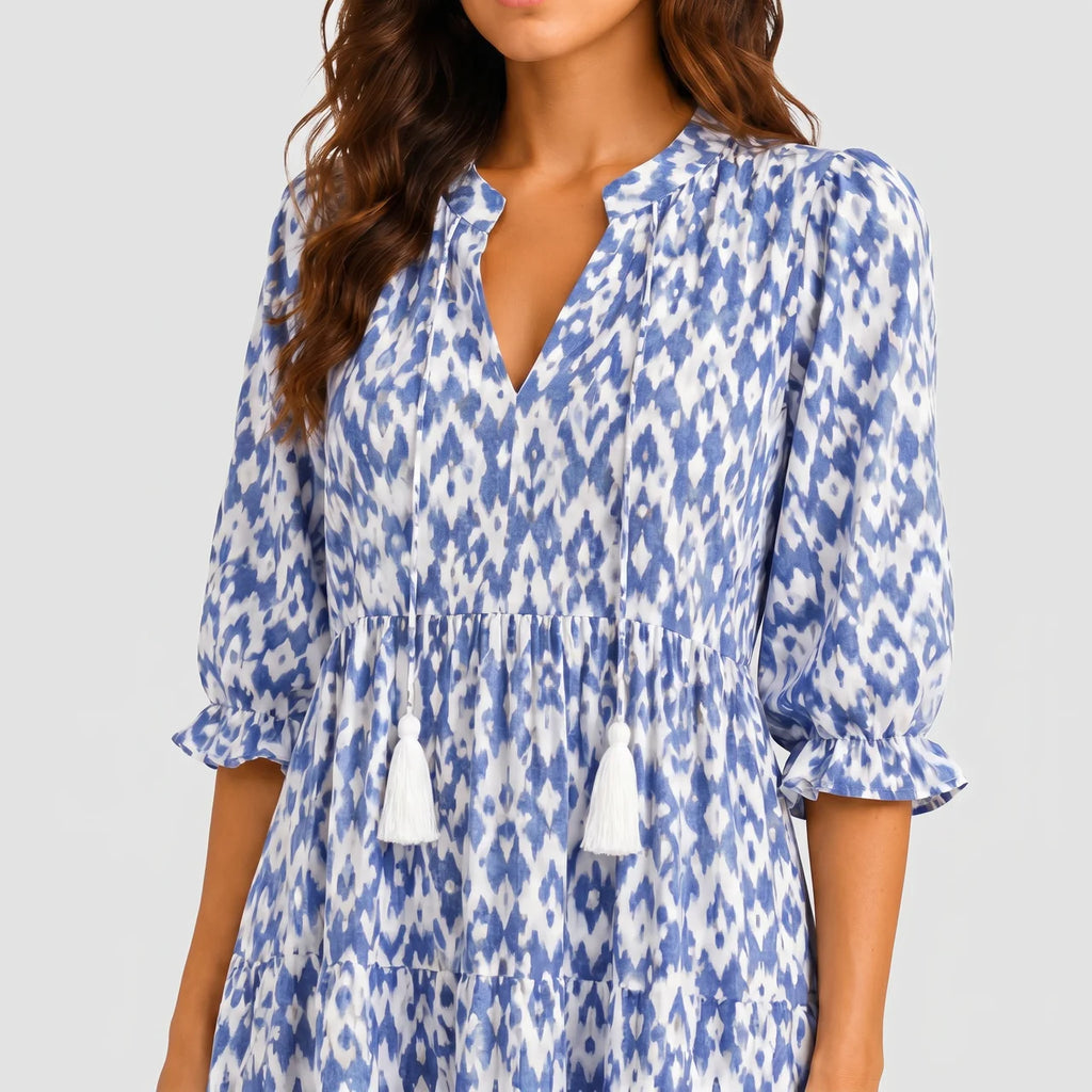 Close-up detail of blue boho lightweight maxi dress with tassel tie neckline and patterned fabric BELLA HUDSON