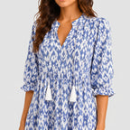 Close-up detail of blue boho lightweight maxi dress with tassel tie neckline and patterned fabric BELLA HUDSON