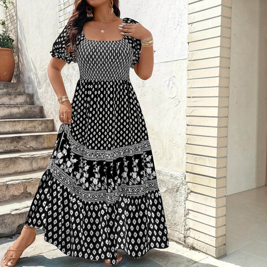 Front view of the Briar Smocked Dress Bohemian Puff-Sleeve Tiered in black, featuring a smocked bodice, square neckline, puff sleeves, and a tiered bohemian maxi skirt. Designed by Bella Hudson.