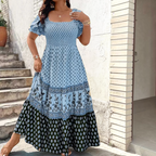 Front view of the Briar Smocked Dress Bohemian Puff-Sleeve Tiered in blue, featuring a smocked bodice, square neckline, puff sleeves, and a flowing tiered maxi silhouette. Designed by Bella Hudson.