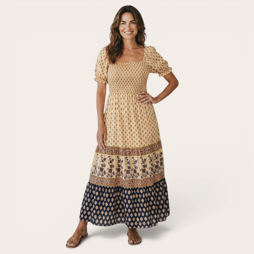 Front view of the Briar Smocked Dress Bohemian Puff-Sleeve Tiered in yellow, featuring a smocked bodice, square neckline, puff sleeves, tiered bohemian print skirt, and a flowing maxi silhouette. Designed by Bella Hudson.