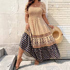 Lifestyle view of the Briar Smocked Dress Bohemian Puff-Sleeve Tiered in yellow, showcasing the flowing tiered skirt, bohemian print hem, and feminine maxi silhouette. Designed by Bella Hudson.