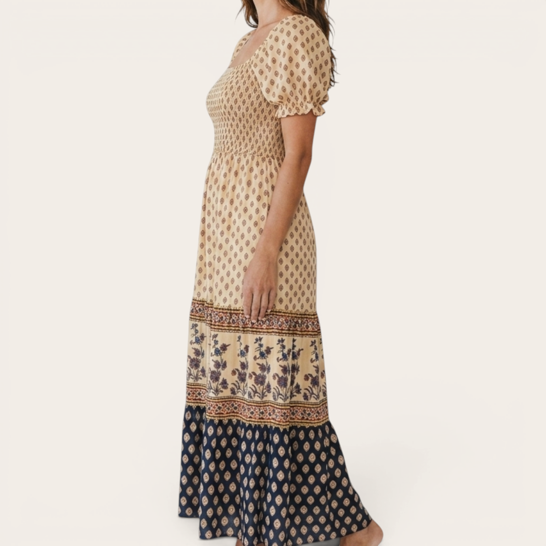 Side view of the Briar Smocked Dress Bohemian Puff-Sleeve Tiered in yellow, showcasing the smocked bodice, puff sleeves, tiered skirt, and relaxed bohemian silhouette. Designed by Bella Hudson.