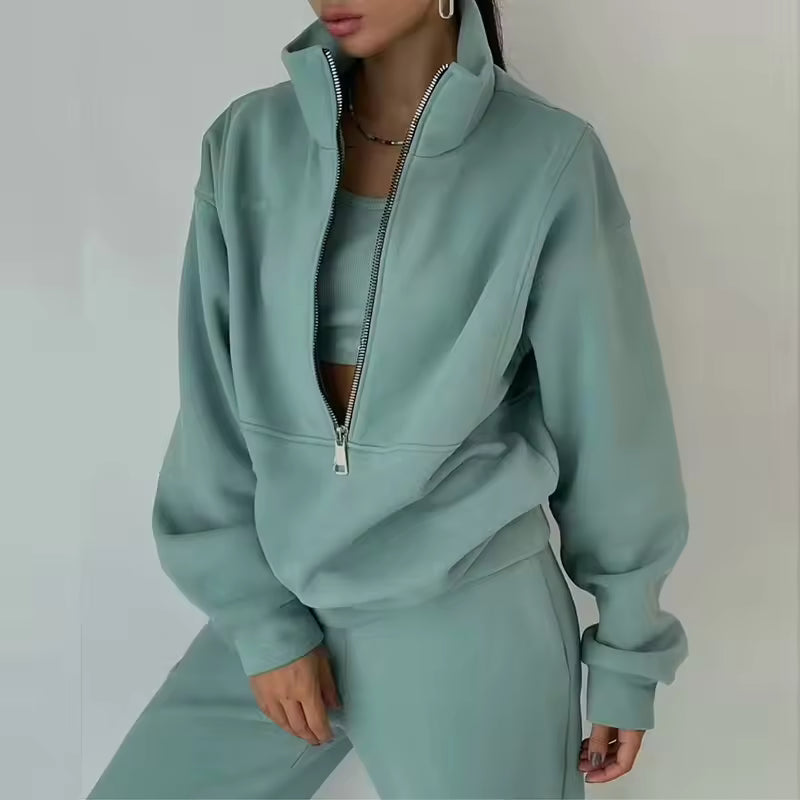 Brielle Green tracksuit set featuring a high-neck half-zip pullover, relaxed sleeves, and coordinating pants