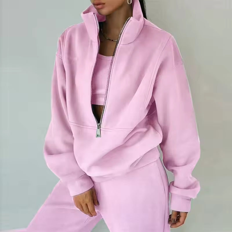 Brielle Pink two-piece tracksuit featuring a high stand collar, partial zipper, and coordinating pants