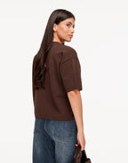 Briony Brown knit T-shirt shown from the back at an angle, highlighting the dropped shoulder seams and straight ribbed hem.