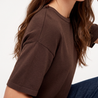Briony Brown knit T-shirt close-up of the dropped shoulder, ribbed sleeve cuff, and knit texture.