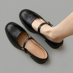 Britt Mary-Jane Flats Block-Heel in Black displayed in an angled view, highlighting the elegant buckle strap, low block heel, closed-toe design, and versatile everyday style, designed by Bella Hudson.