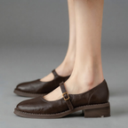 Britt Mary-Jane Flats Block-Heel in Brown displayed in an angled view, highlighting the elegant buckle strap, low block heel, closed-toe design, and versatile everyday style, designed by Bella Hudson.