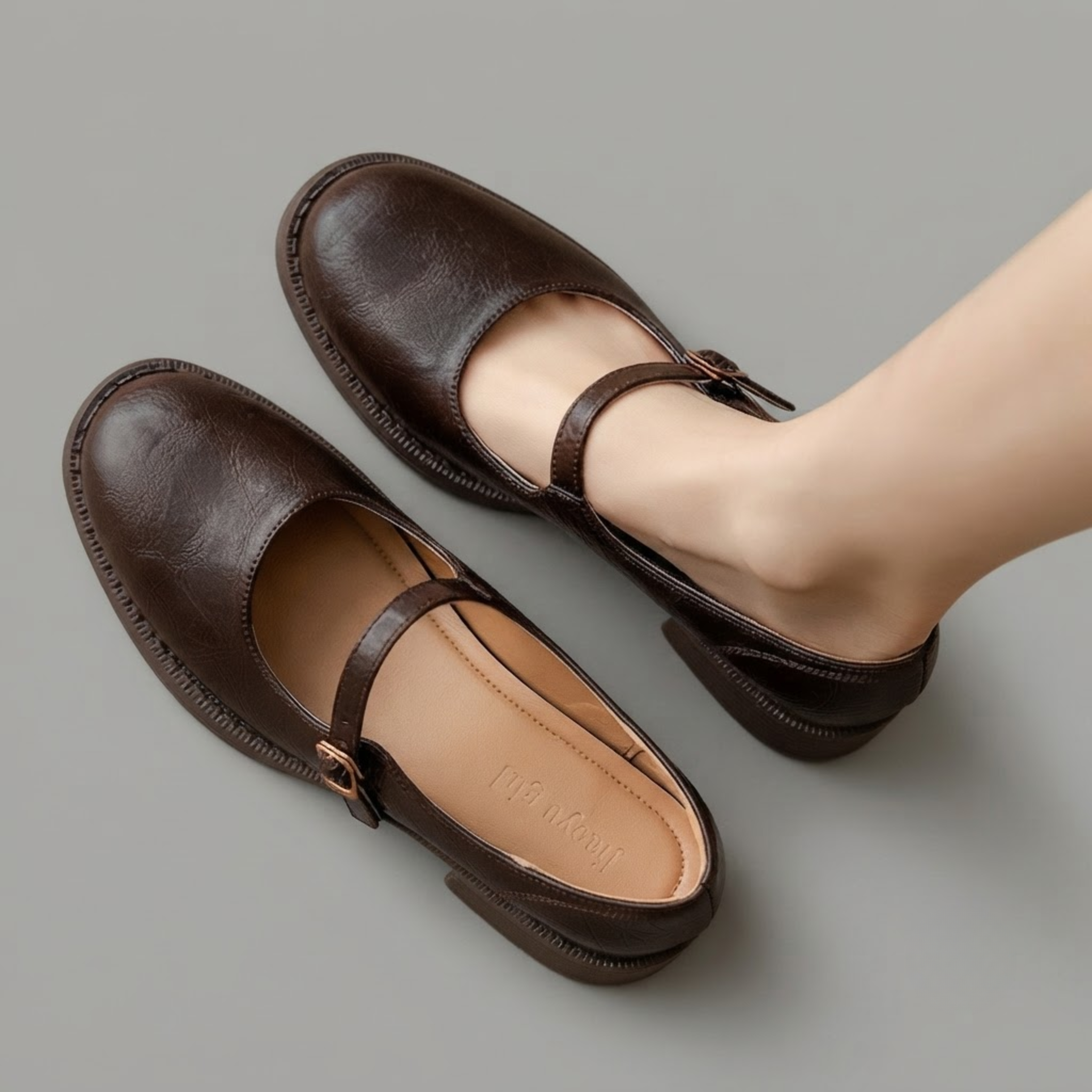 Britt Mary-Jane Flats Block-Heel in Brown shown in front view, featuring a classic closed-toe design, adjustable buckle strap, comfortable low block heel, cushioned footbed, and timeless Mary Jane silhouette, designed by Bella Hudson.