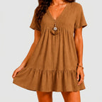 Front view of brown boho tiered mini dress with short sleeves and V-neckline by BELLA HUDSON
