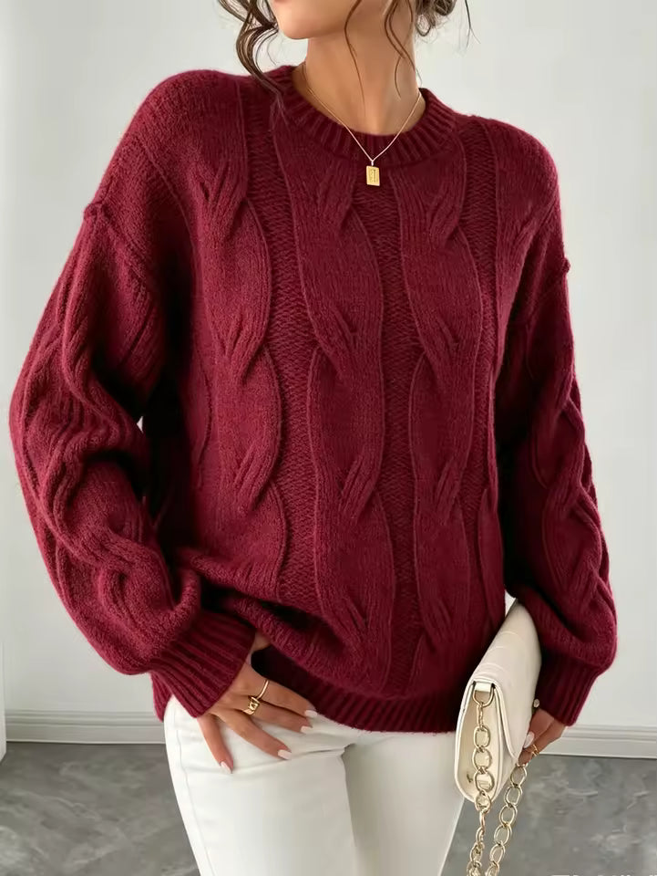 Camila Red cable-knit sweater with vertical braided detailing and relaxed silhouette, styled with pants