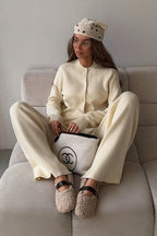 Camille Beige knit cardigan lounge set shown seated with a button-front cardigan and relaxed wide-leg pants