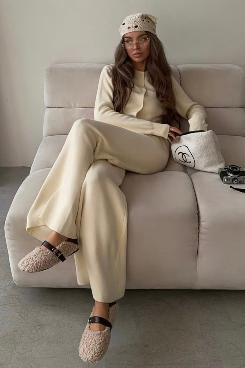 Camille Beige knit cardigan lounge set styled seated, featuring a round-neck cardigan with long sleeves and matching wide-leg pants
