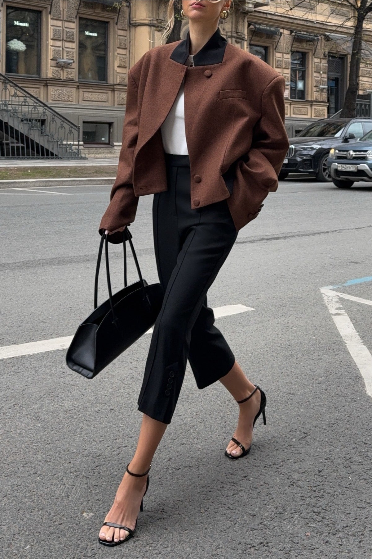 Camille Brown cropped jacket shown while walking with structured shoulders, long sleeves, and a relaxed tailored shape