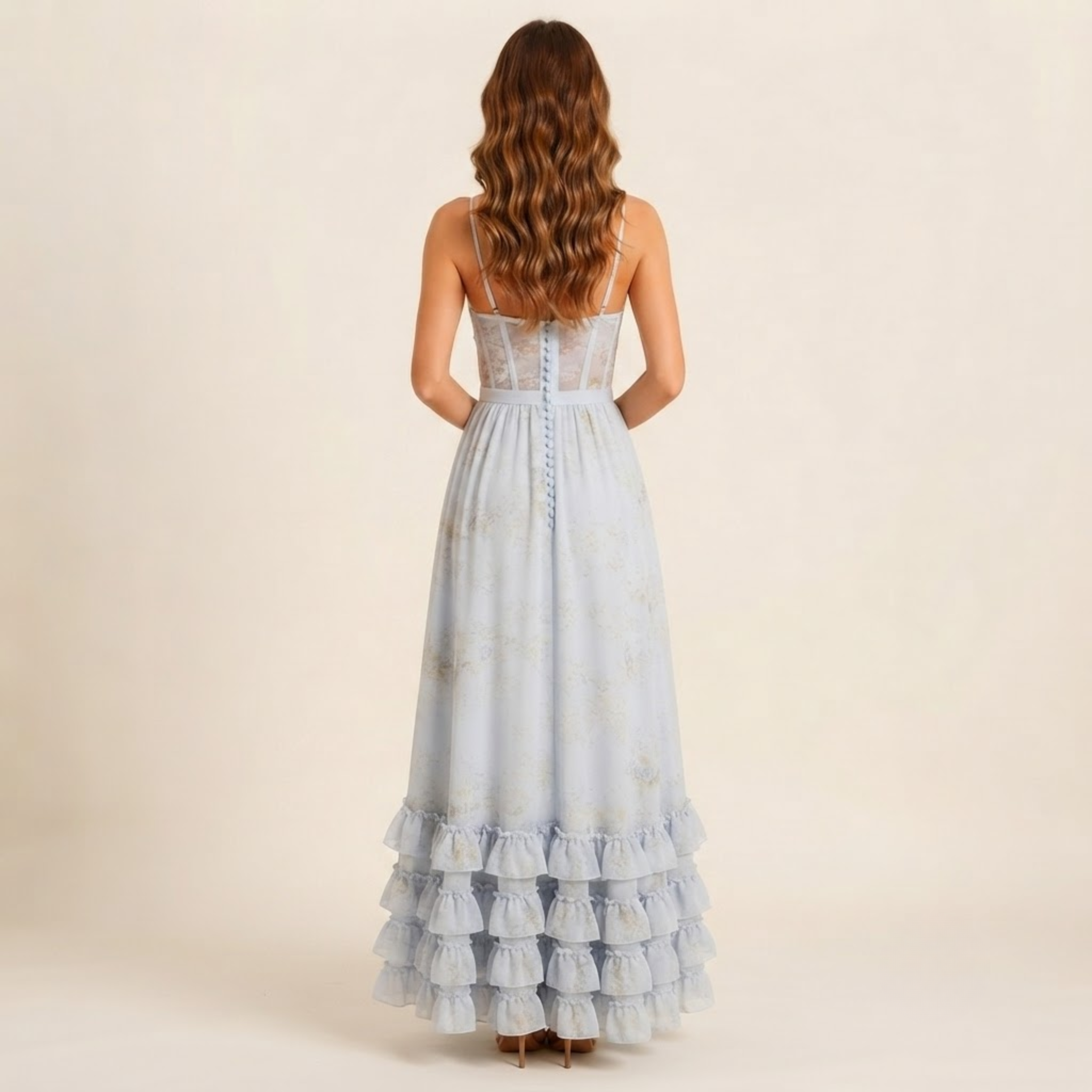 Back view of the Camille Maxi Dress Floral-Print Ruffle Side-Slit in Blue, showcasing the flowing maxi length and flattering fit. Designed by Bella Hudson.