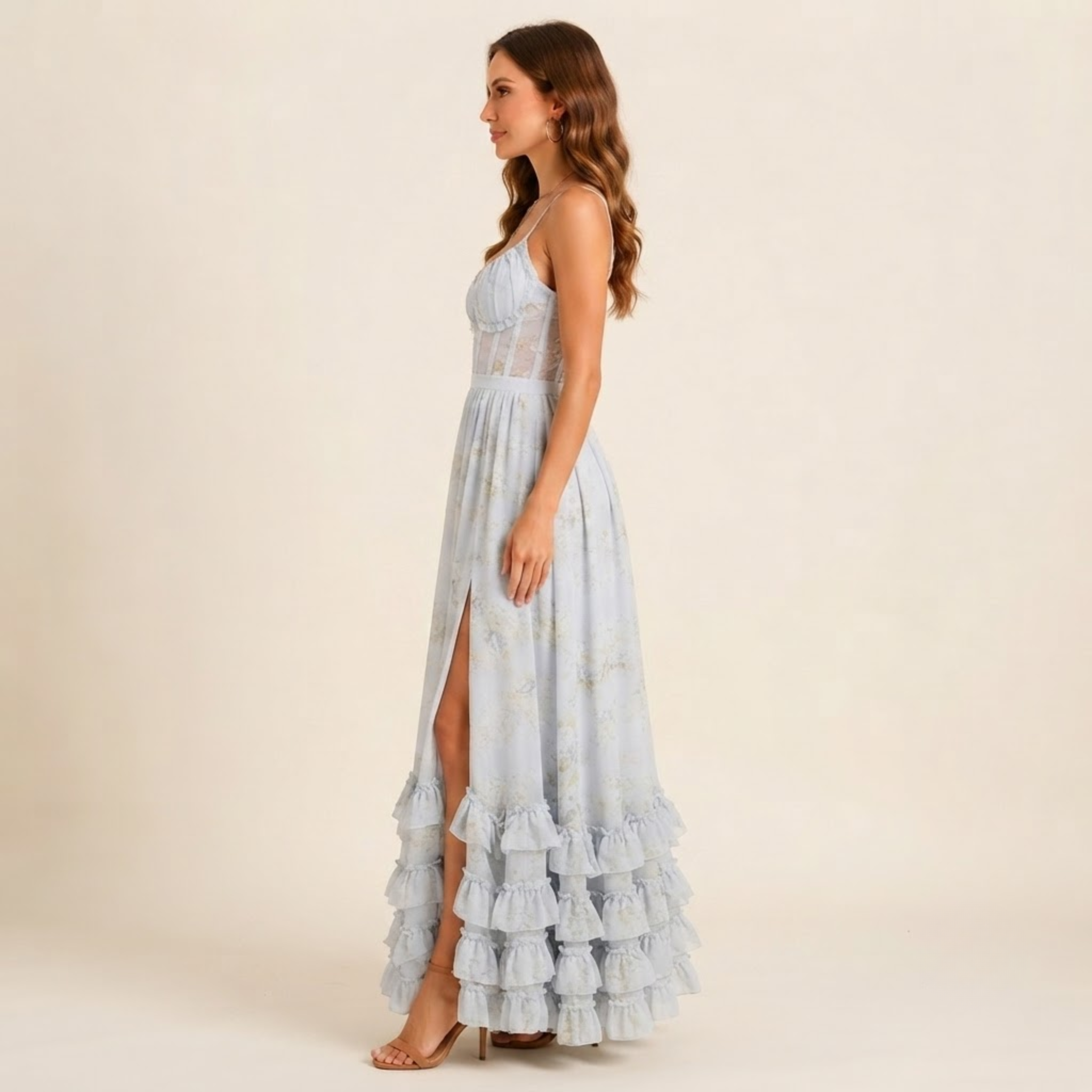 Left side view of the Camille Maxi Dress Floral-Print Ruffle Side-Slit in Blue, highlighting the graceful side slit and flowing silhouette. Designed by Bella Hudson.