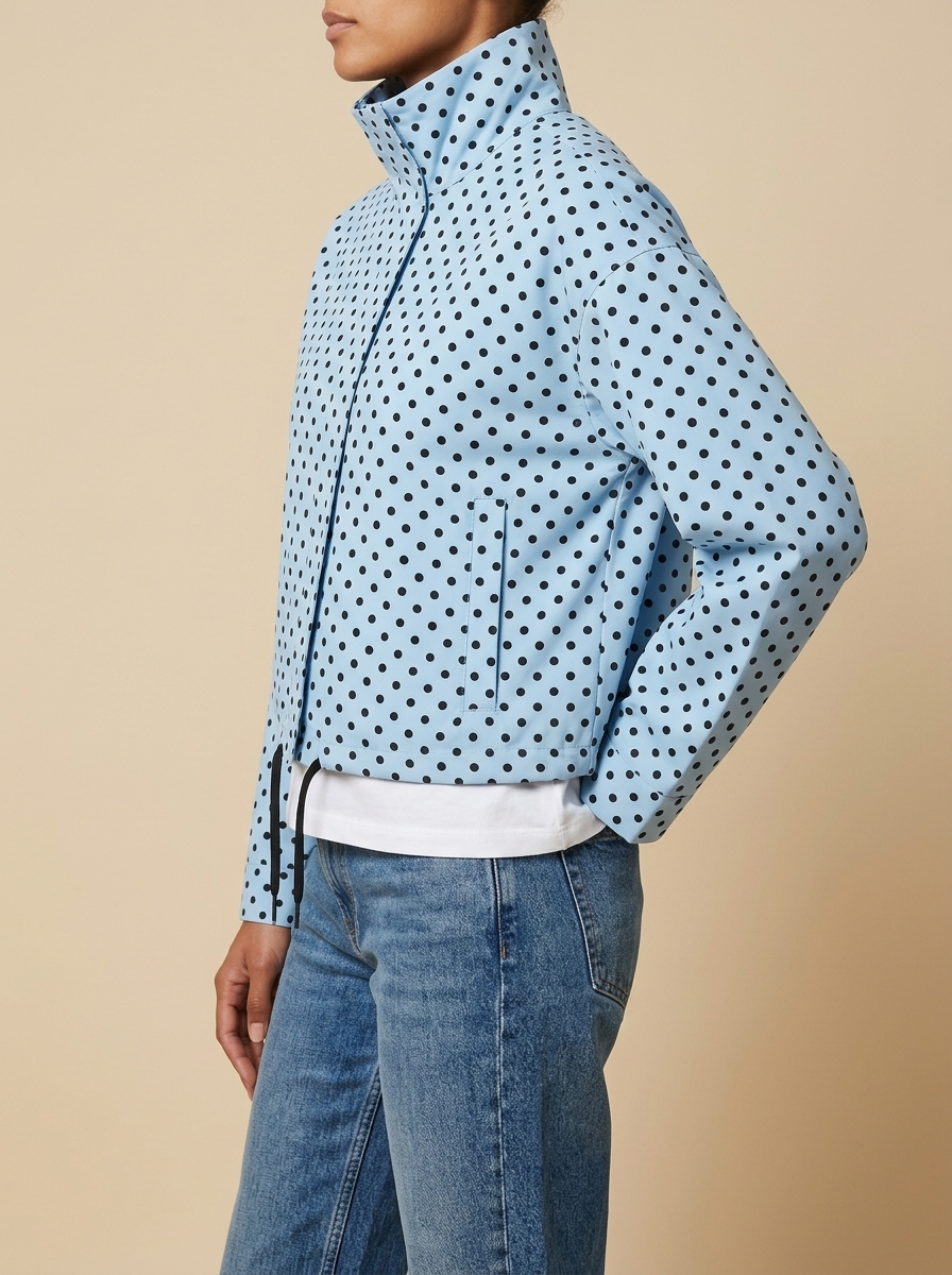 Side view of the light blue Camille Polka-Dot High-Neck Bomber Jacket for Women featuring a high neck, relaxed shape, and dot print.