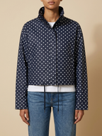 Front view of the navy Camille Polka-Dot High-Neck Bomber Jacket for Women featuring a zip-through front, high neck, and dot print.