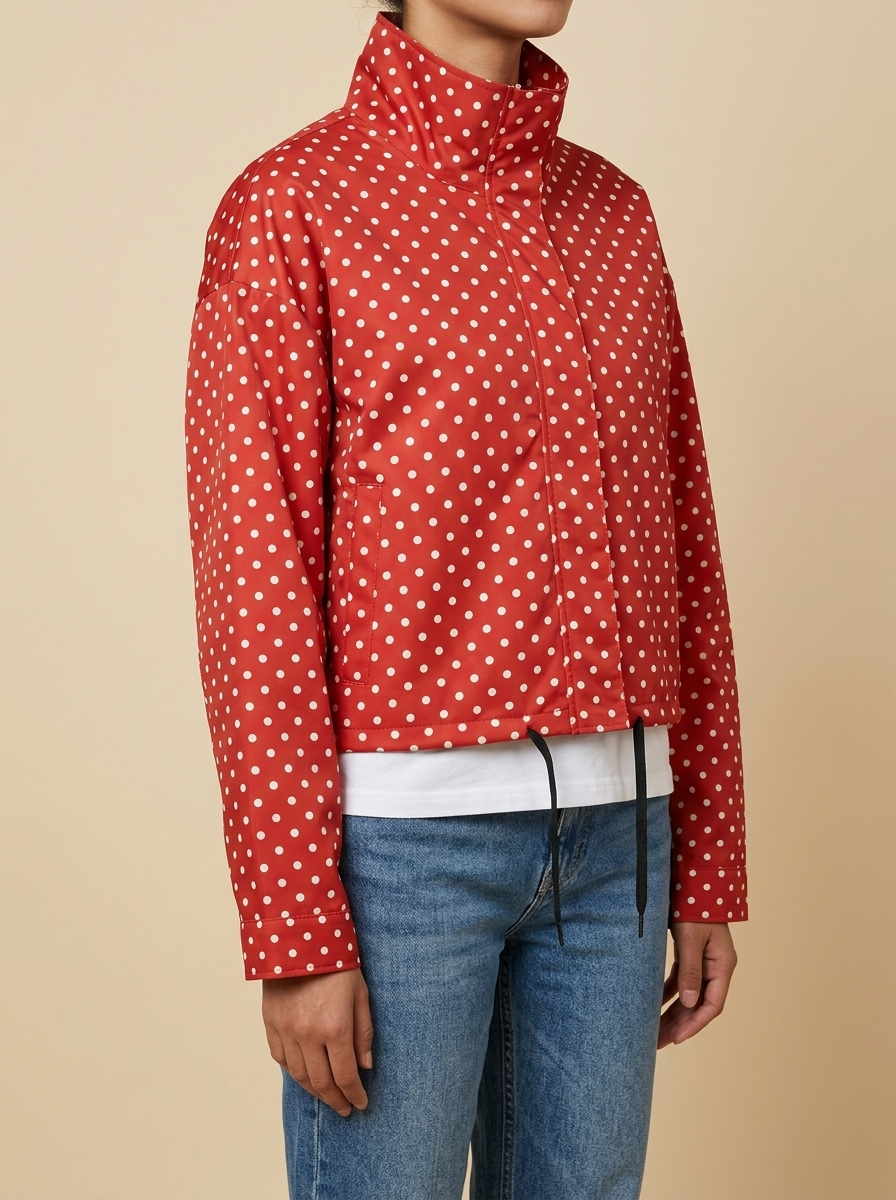 Three-quarter view of the red Camille Polka-Dot High-Neck Bomber Jacket for Women featuring a high neck, long sleeves, and dot print.