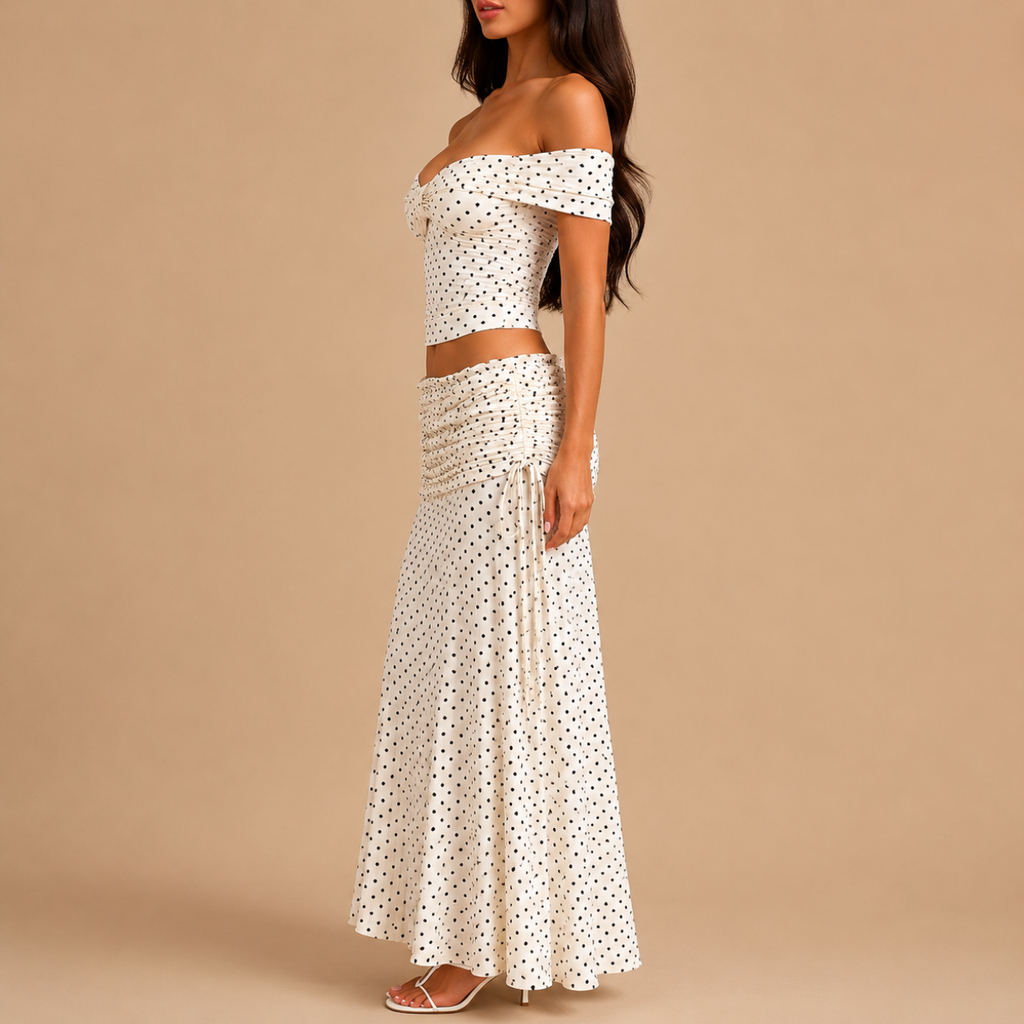 Side view of the Candice Polka Dot Skirt and Off-the-Shoulder Top Set featuring a fitted off-the-shoulder top and flowing maxi skirt. Designed by Bella Hudson.
