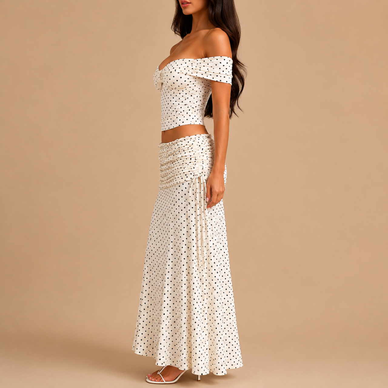 Side view of the Candice Polka Dot Skirt and Off-the-Shoulder Top Set featuring a fitted off-the-shoulder top and flowing maxi skirt. Designed by Bella Hudson.