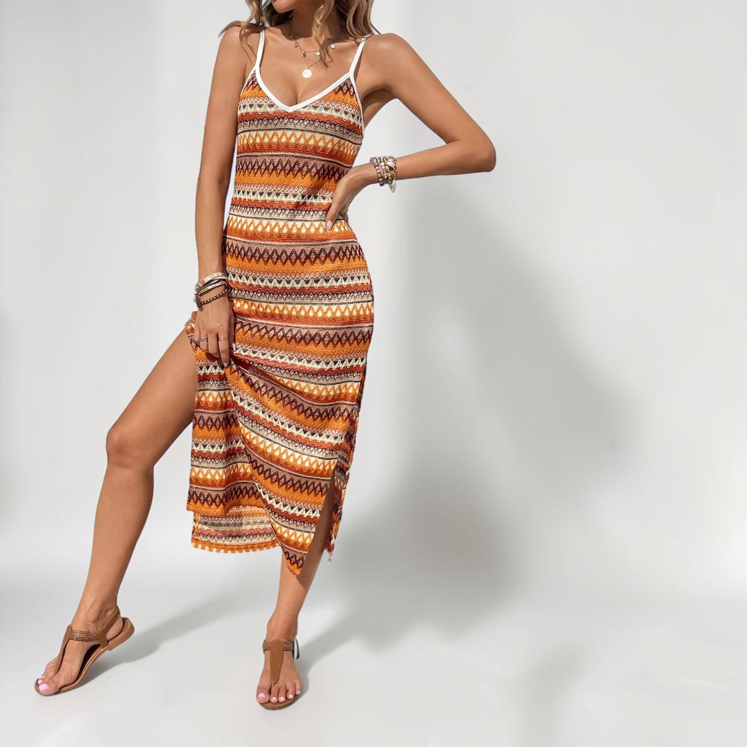Front view of the Cassia Maxi Dress Knit Striped Cami Side-Slit in orange, featuring a sleeveless cami neckline, striped knit fabric, body-skimming silhouette, and side slit. Designed by Bella Hudson.