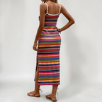 Lifestyle back view of the Cassia Maxi Dress Knit Striped Cami Side-Slit in pink, highlighting the colorful striped knit pattern, sleeveless silhouette, and flowing maxi length. Designed by Bella Hudson.