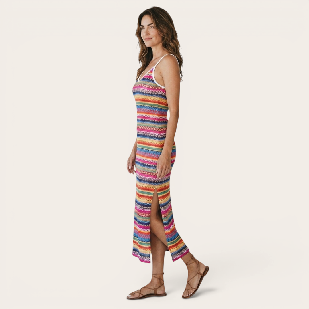 Side view of the Cassia Maxi Dress Knit Striped Cami Side-Slit in pink, showcasing the sleeveless cami straps, striped knit fabric, body-skimming fit, and side slit. Designed by Bella Hudson.