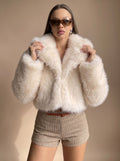 Charlotte Beige cropped faux-fur jacket styled with a relaxed open front, wide lapel collar, oversized sleeves, and short silhouette