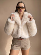 Charlotte Beige cropped faux-fur jacket styled with a relaxed open front, wide lapel collar, oversized sleeves, and short silhouette
