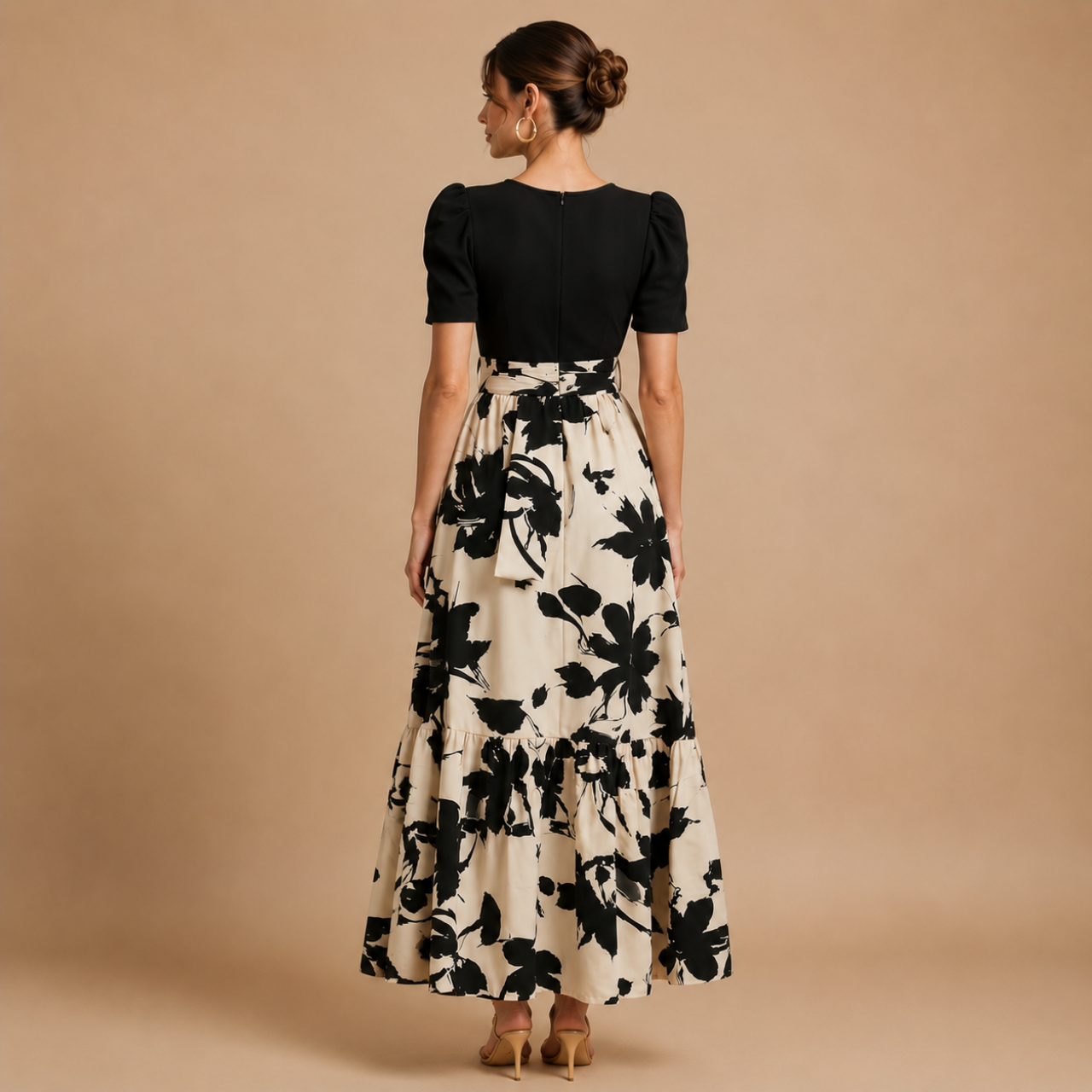 Back view of the Claire Bow-Tie Maxi Dress with black bodice and cream floral print maxi skirt. Designed by Bella Hudson.