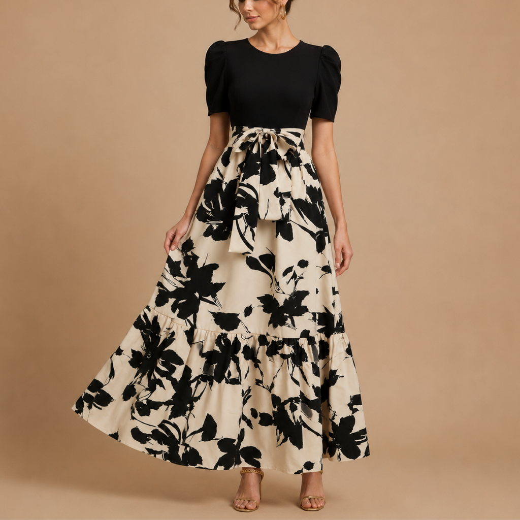 Detailed view of the Claire Bow-Tie Maxi Dress highlighting the floral print fabric and bow-tie waist detail. Designed by Bella Hudson.