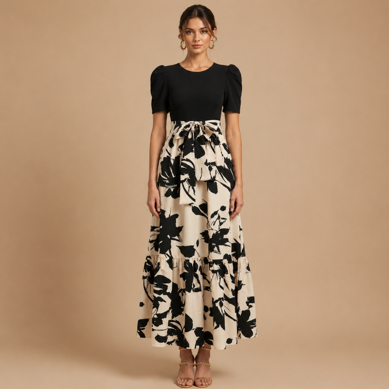 Claire Bow-Tie Maxi Dress featuring a black bodice and cream floral print maxi skirt front view. Designed by Bella Hudson.