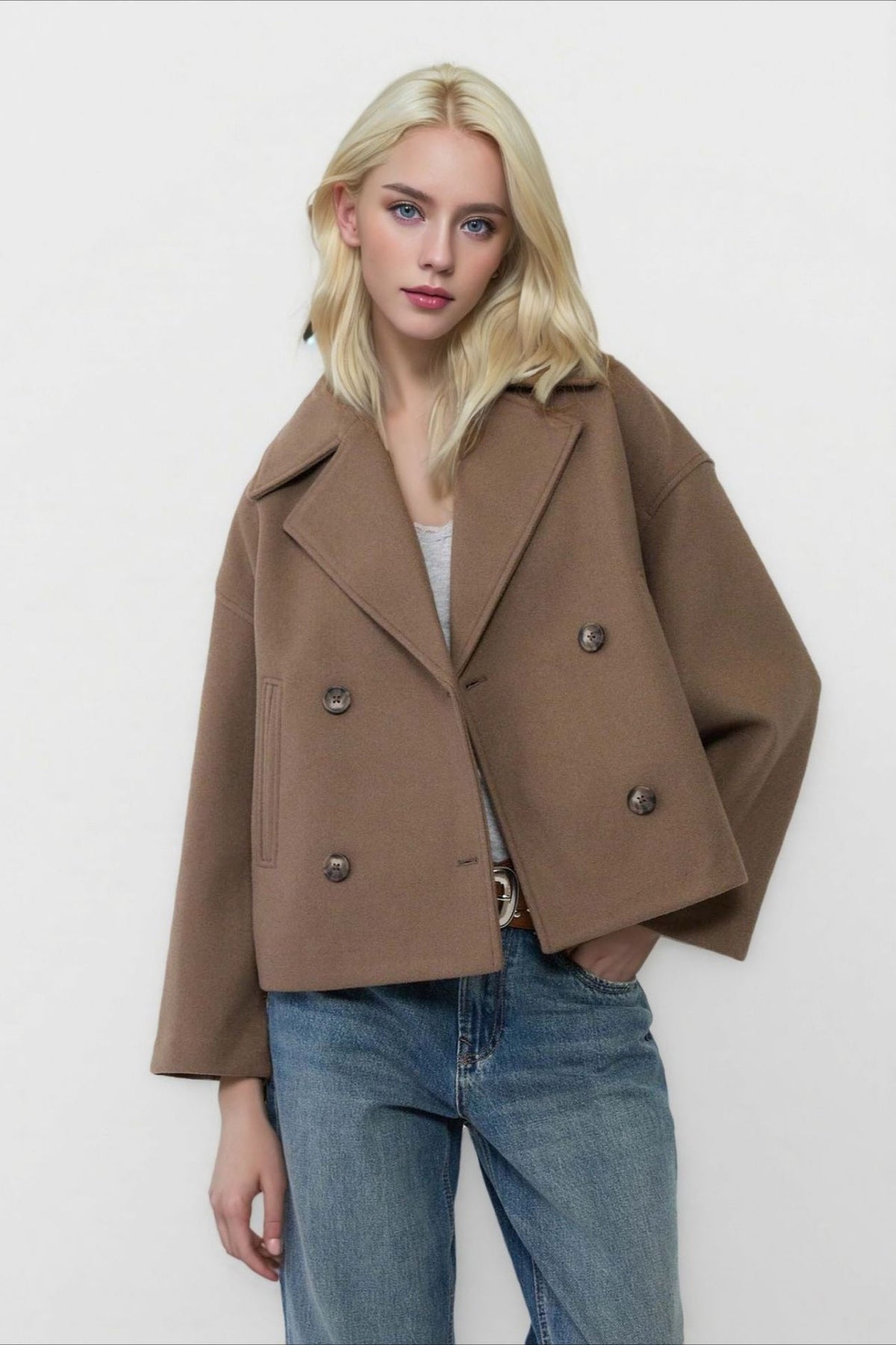 Clara Brown cropped double-breasted coat featuring a structured wide-lapel neckline, relaxed silhouette, and double-row buttons