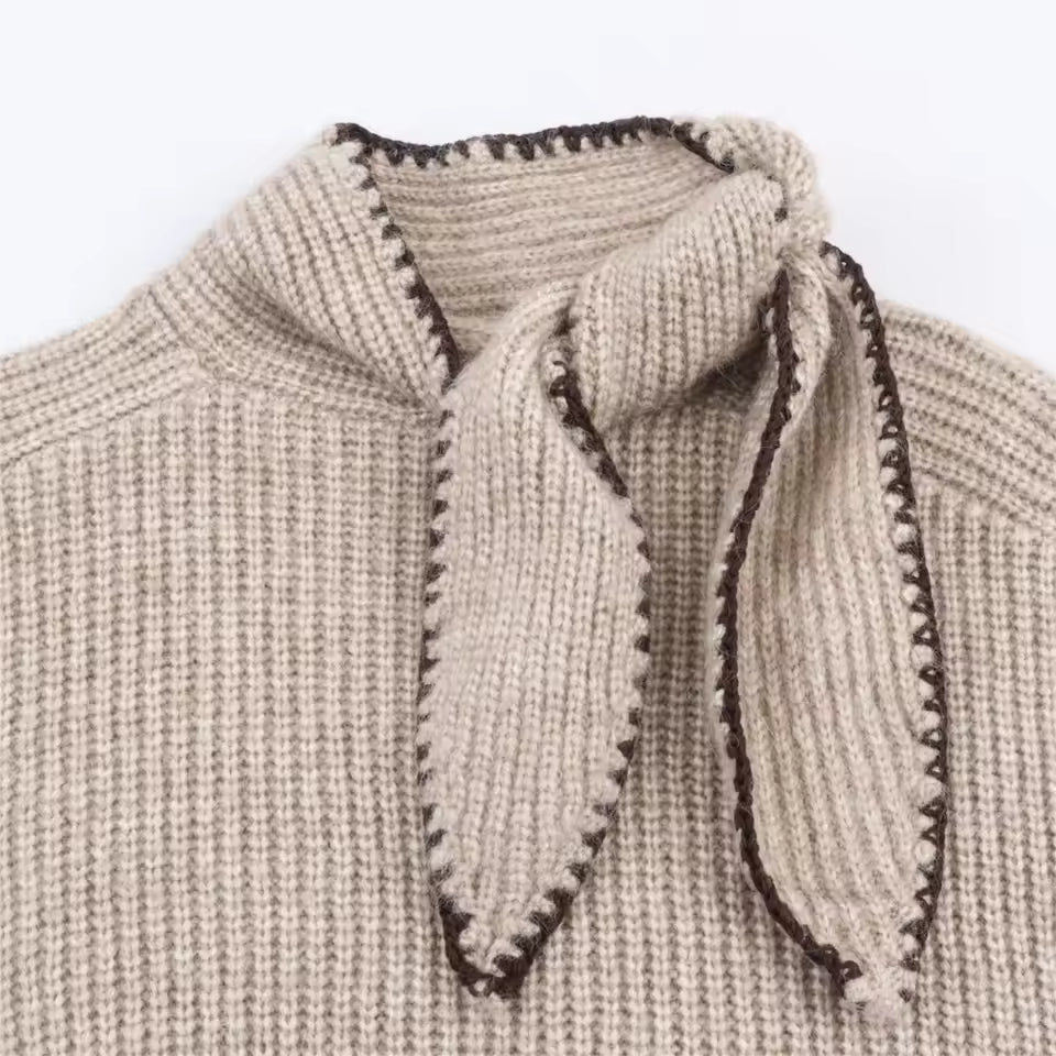 Close-up of Clara Khaki ribbed knit sweater showing the stand collar, decorative necktie, and textured knit fabric